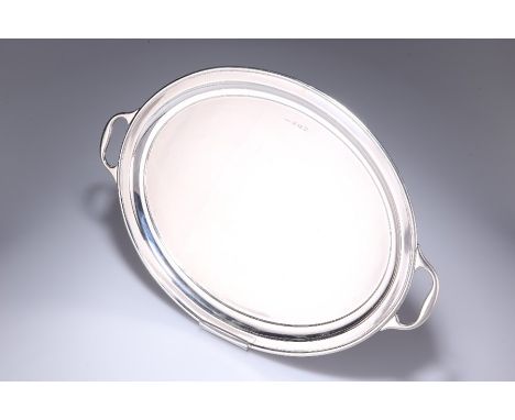 A LARGE GEORGE V SILVER TRAYby Joseph Gloster Ltd, Birmingham 1930Oval with twin handles.47.2cm long, 32.5cm wide. 46.3 troy 