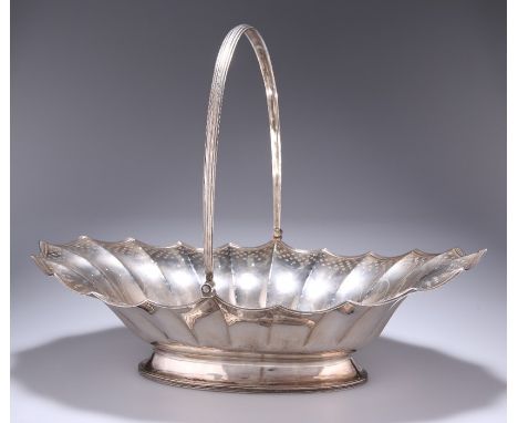 A GEORGE III SILVER SWING-HANDLED BASKETLondon 1788Shaped oval form with reeded edge and handle, bright-cut engraved with sca