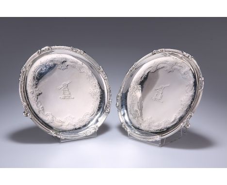 A PAIR OF GEORGE II SILVER WAITERSby John Swift, London 1753Circular with reeded and leaf edge, each engraved with a crest wi