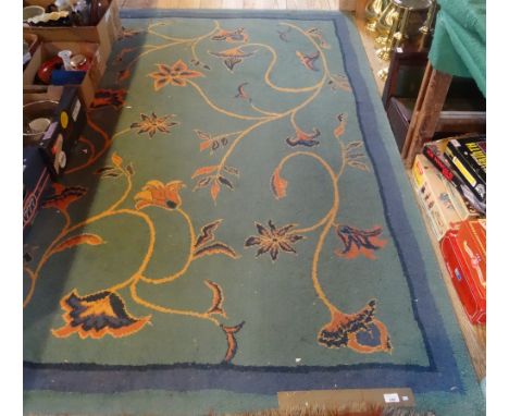 A modern carpet/rug, having stylized floral decoration on a blue ground (228cm x 163cm).