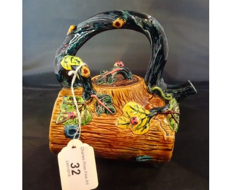 A Taiwan-Cochin ceramic teapot, formed as a log with loop handle, decorated with ladybirds (15cm).