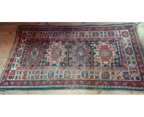 An Indian rectangular carpet, with four central lozenges within mushroom border (184cm x 110cm).