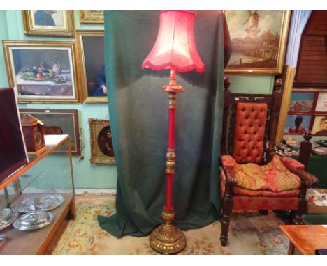 A French-style giltwood standard lamp, having part fabric covered column on a moulded circular base (164cm) not including sha