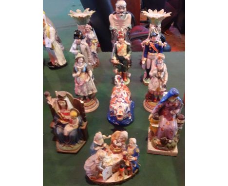 A quantity of ceramic figurines, to include: examples of oriental interest and a cow creamer in the Imari palette.