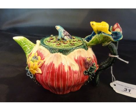 A 20th century Taiwan-Cochin ceramic teapot, profusely decorated in the form of a folded lotus leaf with applied flower and f