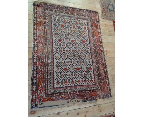 An Eastern rectangular carpet, having repeating geometric central panel within repeating patterned border (153cm x 115cm). Co