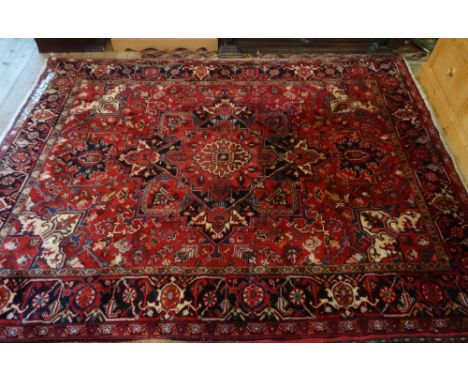 An Iranian Heriz carpet (290cm x 215cm).