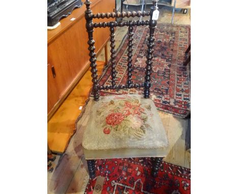 An Arts & Crafts-style bobbin turned chair, having embroidered tapestry seat.
