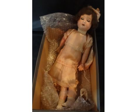 A 20th century Max Oscar Arnold bisque headed doll, having sleeping blue eyes, open mouth with four teeth showing, jointed co