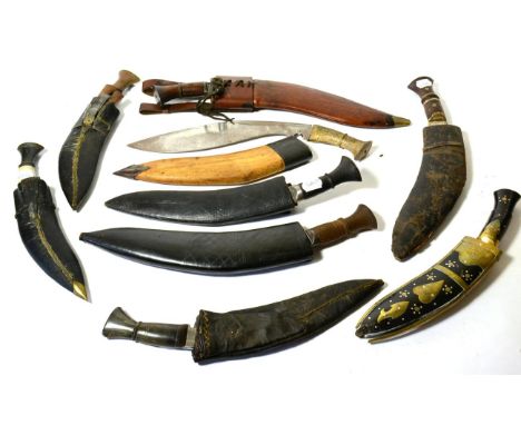 A Nepalese Kukri, the 33cm curved steel blade with notch at the ricasso and double fullers running along the back edge, the w