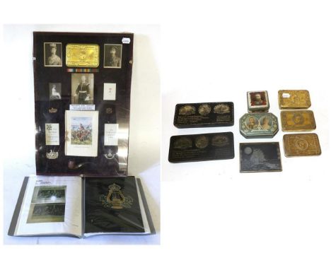 A Princess Mary 1914 Christmas Tin Framed Display, comprising tin with various inserts and photographs of royalty, pipe, cap 