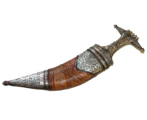 An Arab Jambiya, with foliate embossed silver covered hilt and leather scabbard with similar decoration
