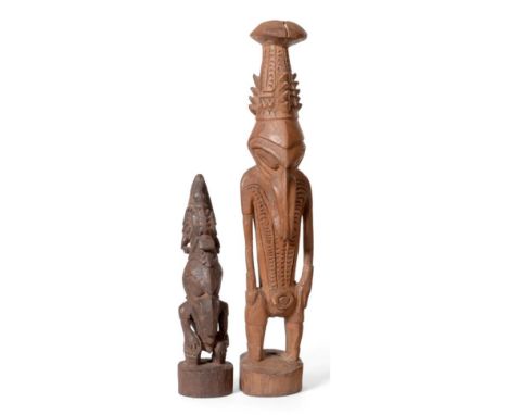 Two Early 20th Century Sepik River Spirit/Ancestor Figures, Papua New Guinea, each of light hardwood, standing wearing a high