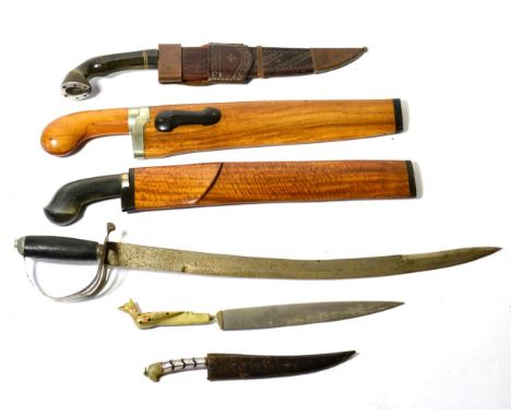 An Indonesian Golok, the 33.5cm clip-point curved steel blade with inlaid brass line to the back edge, with horn pistol grip 