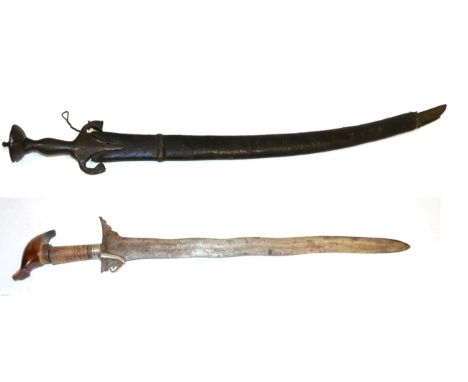 A 19th Century Indian Talwar, the 75cm single edged curved steel blade with a narrow fuller running along the back edge, the 