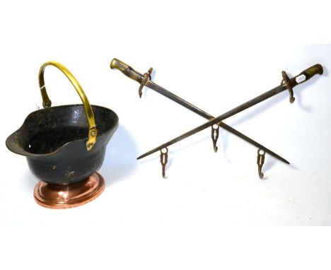 A First World War Trench Art Coal Skuttle, made from the shell of a German M16 combat helmet, painted black, with brass swing