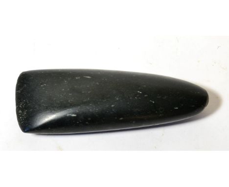 A Highlands Black Stone Axe Head, Papua New Guinea, of typical form, 24cm by 8cm 