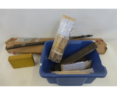 A quantity of Peco Streamline model railway track and a box of model railway accessories.