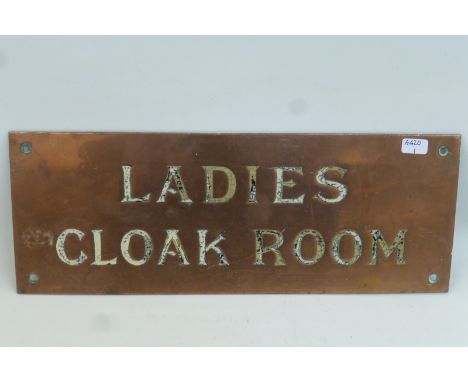 A "Ladies Cloak Room" rectangular copper plaque with inset enamel letters, 12 x 4 1/2".