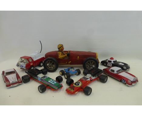 A large scale wooden model of a racing car and a selection of tinplate model cars.