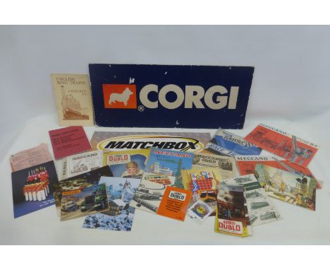 A Corgi shop window showcard and another for Matchbox; also a selection of toy related brochures including Hornby, Meccano, S
