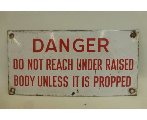 A rectangular enamel sign -"Danger do not reach under raised body unless it is propped", 10 x 5".