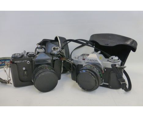 A Canon AV-1 camera plus lens and a Zenit E.M. camera.