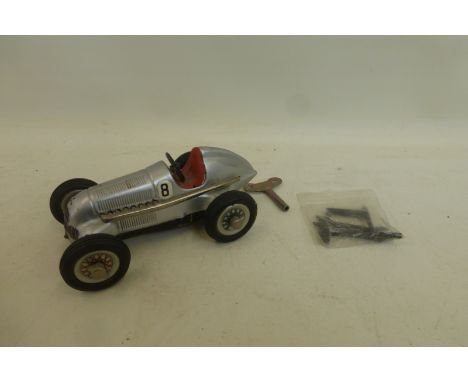 A Schuco Studio 1050 tinplate clockwork model of a single seater Mercedes racing car.