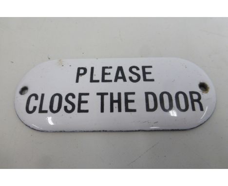 A small black and white enamel plaque "Please Close the Door", 4 x 1 3/4".