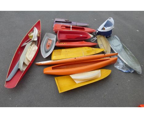 A collection of large model remote controlled boats, mostly fibreglass hulls.