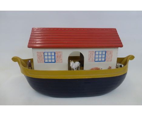 A large wooden model of Noah's Ark in four sections, with four pairs of animals, 25 1/2 inches long and 13 inches high.