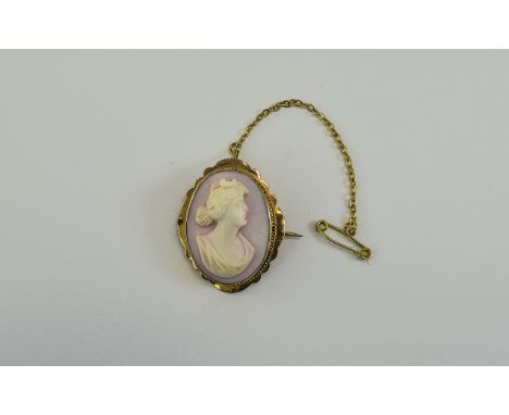 A Vintage - Nice Quality 9ct Gold Set Oval Shaped Cameo, with Attached 9ct Gold Safety Chain. Marked 9ct. 5.5 grams. Pristine