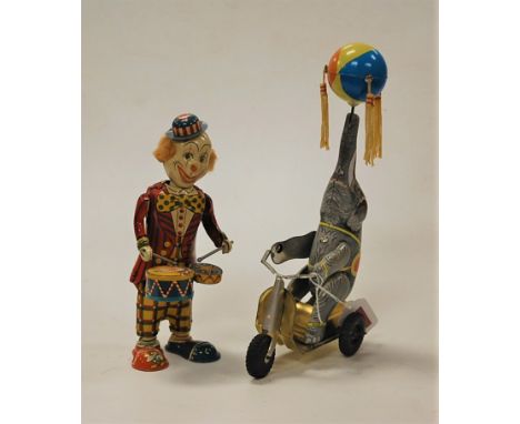 A lithograph printed metal clockwork clown drummer, h.20cm; together with another of a performing seal on a scooter (2)