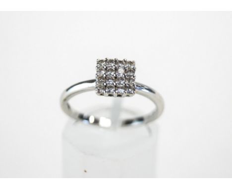 A sixteen stone diamond 18 carat white gold cluster ring, the brilliant cuts in four by four arrangement, totallling approxim