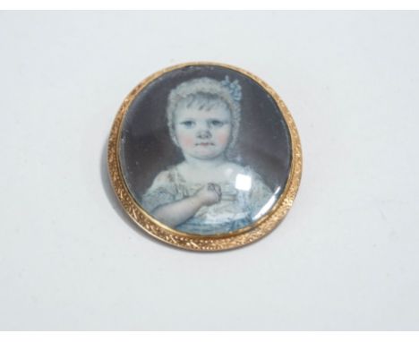 A late 18th Century miniature portrait brooch, the image of a young child to a prick dot mount, inscribed to the reverse 'Gri