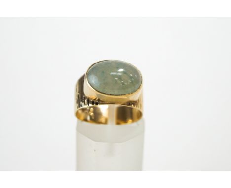 A Jade ring, the mount stamped '9ct', the cabochon, approximately 1.4 cm by 1 cm, finger size M, 4.5 g gross