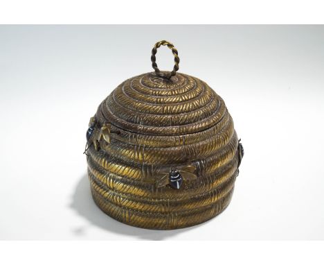 A Mottahedeh brass novelty tin, modelled as a bee hive with applied bees, hinged lid and push button opening mechanism, stamp