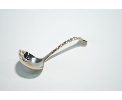 A silver sauce ladle, Sheffield 1973, with Celtic design in relief, 11.5 cm long, 24.6 g gross