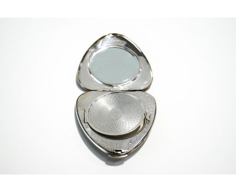 A Kigu silver compact, London 1960, of almost heart shape, decorated with a bird on a branch against a short silk like ground