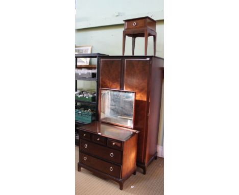 A MAHOGANY FINISHED STAG BEDROOM SUITE comprising mirror backed dressing chest, wardrobe &amp; single drawer bedside unit 