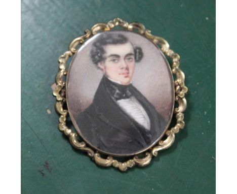 A MID 19TH CENTURY PORTRAIT MINIATURE PAINTING , bust of a young gentleman, wearing a black jacket &amp; cravat. 5cm x 4.2cm 