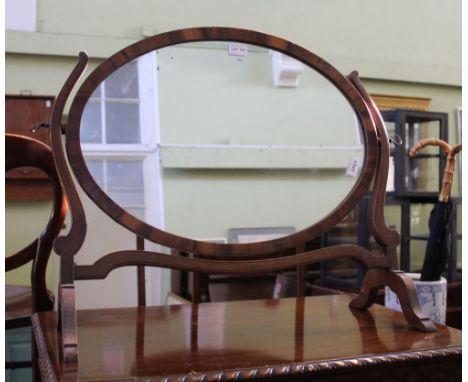 A 19TH CENTURY ROSEWOOD FRAMED OVAL BEVEL PLATE DRESSING TABLE MIRROR on mahogany twin horn support 