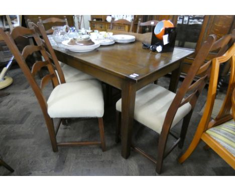 A dark oak refectory style extending rectangular dining table, two additional leaves and six chairs in the ladder back style 