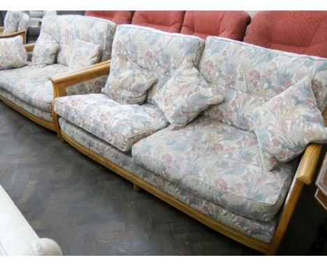 An Ercol three piece lounge suite comprising large two seater sofa, small two seater sofa and matching armchair 