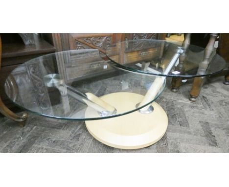 A contemporary light oak and plate glass top coffee table with adjustable glass panels 