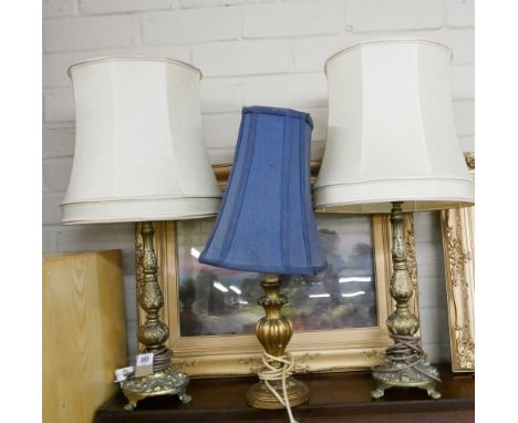 A pair of gilt metal table lamps with shades and one off wooden lamp with blue shade