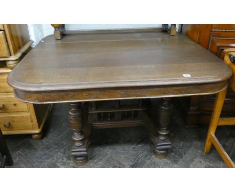 A French oak dining table on quadruple pillar style base 