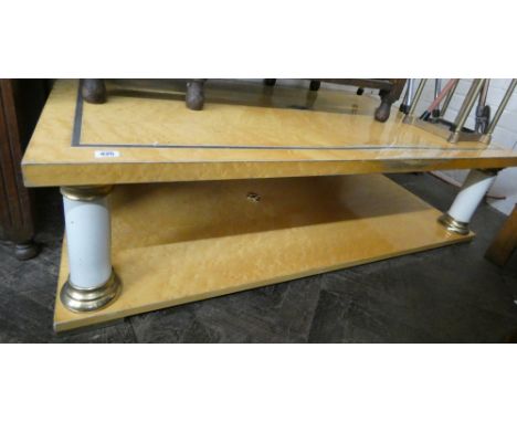 A Birdseye maple blond wood two tier coffee table with pillar style supports 