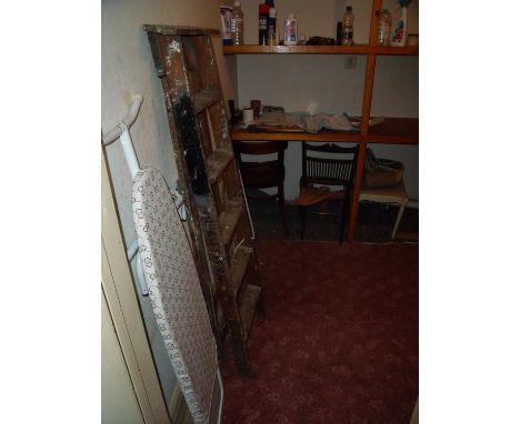 Contents of storeroom including wooden folding step ladders, various chairs, ironing board, clothes racks etc 
