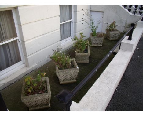 Set of four composite stone planters and a rectangular stone planter 